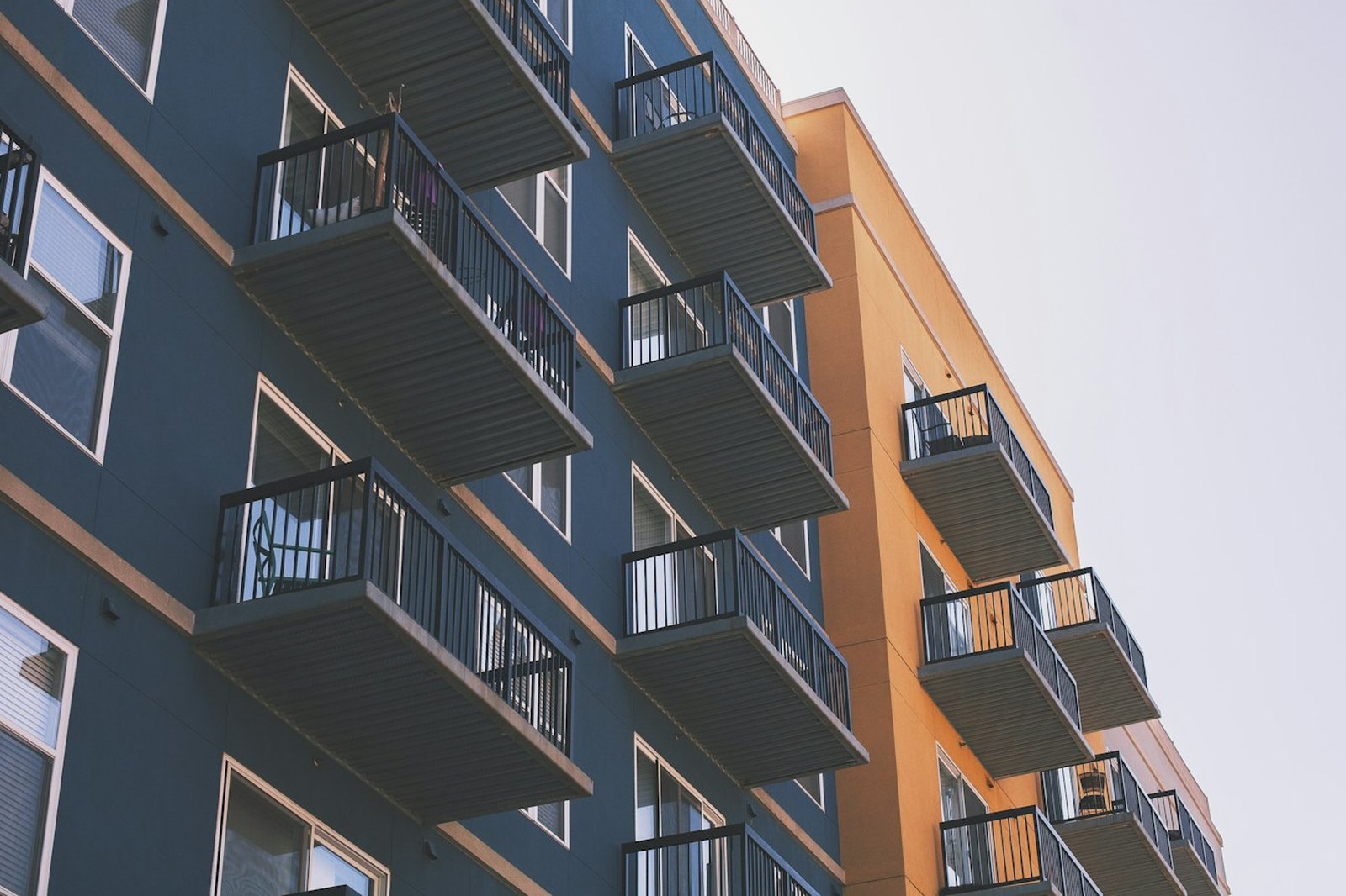 Balcony rails and glazing across the upper floors of an income property