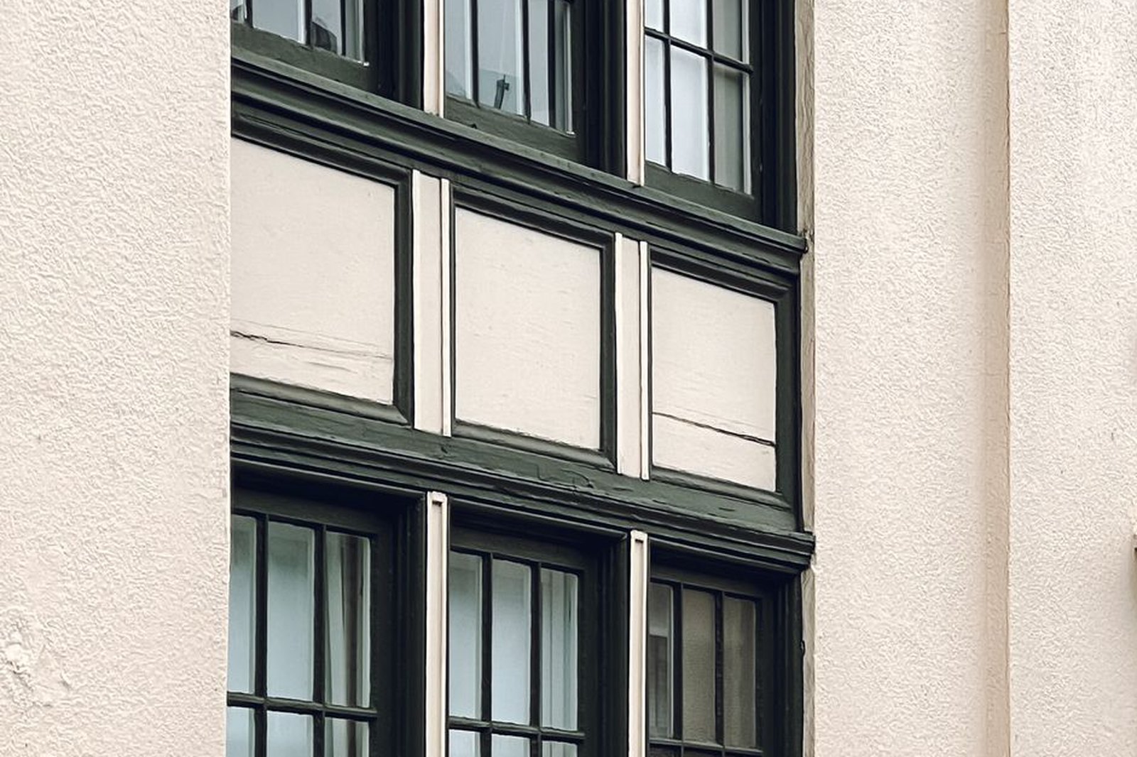 Entry door and window bays of a quiet low-rise commercial building